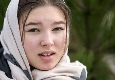 Teen girl in headscarf close-up face - winter outdoors