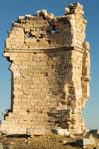 Cross on rock against clear blue sky