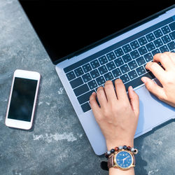 Low section of person using laptop on table