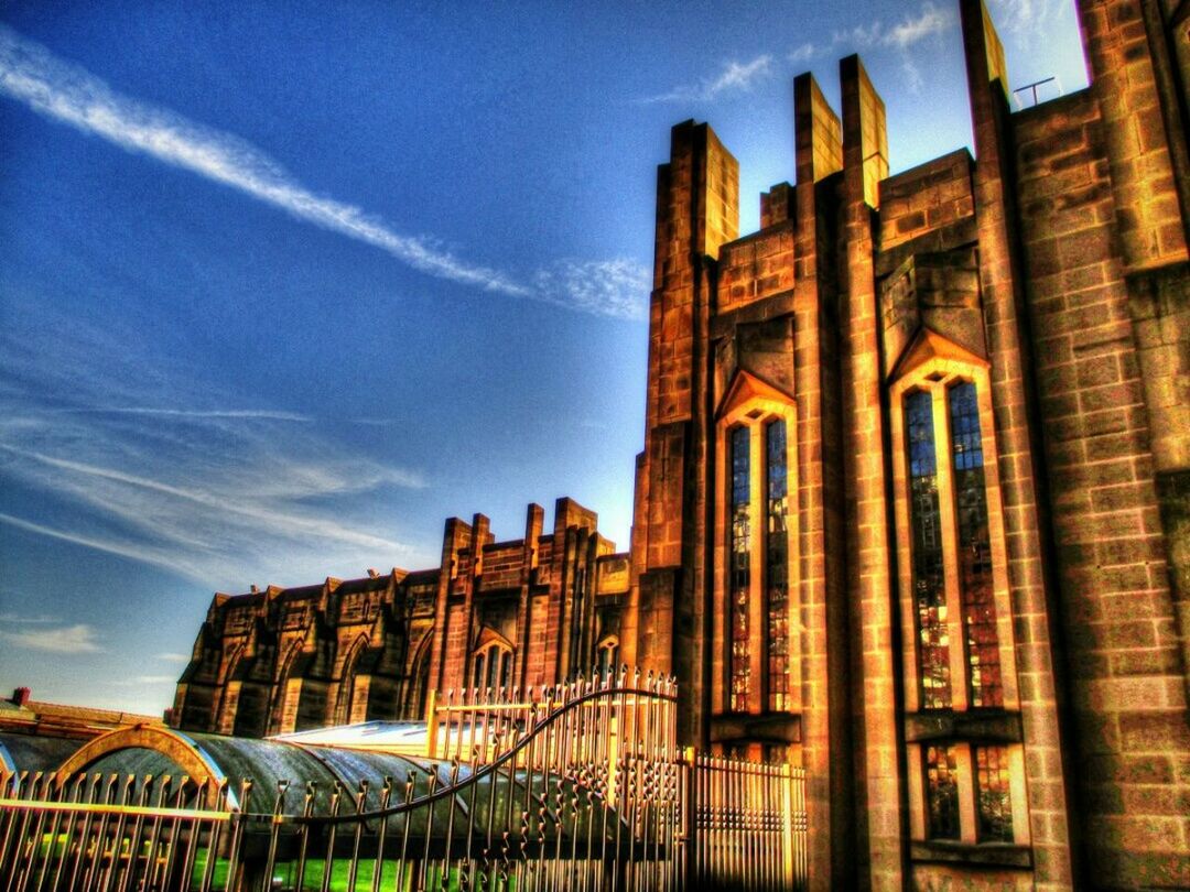 architecture, built structure, building exterior, sky, low angle view, cloud - sky, old, building, window, exterior, history, cloud, residential structure, residential building, outdoors, no people, city, church, blue, sunlight