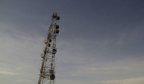 Low angle view of communications tower against sky