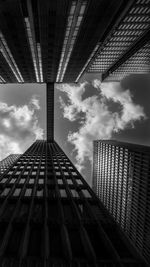 Low angle view of modern building against cloudy sky