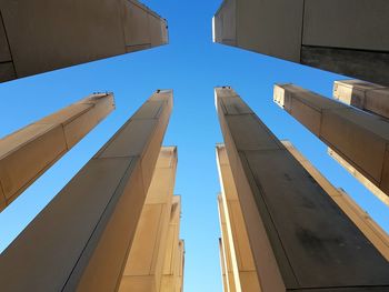 Low angle view of a war memorial against clear blue sky