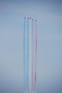 Low angle view of airshow against sky