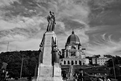 Low angle view of statue against cloudy sky