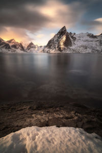 Scenic view of lake against sky during winter