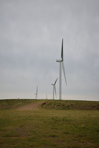 Windmill on field against sky