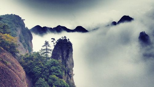 Dramatic mountain range surrounded by mist