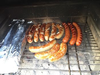 High angle view of meat on barbecue grill