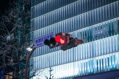 Low angle view of illuminated light against building