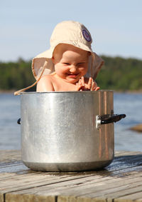 Cute girl sitting in pot 