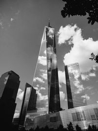 Low angle view of buildings against cloudy sky