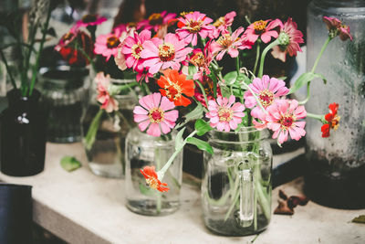 Close-up of flowers in glass jar on table