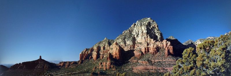 Scenic view of rocky mountains against blue sky