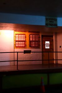 Low angle view of illuminated sign on wall at night