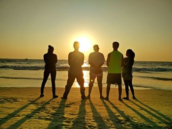 People on beach at sunset