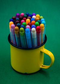 Close-up of multi colored drinking straws against blue background