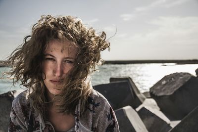 Portrait of young woman during windy weather at beach