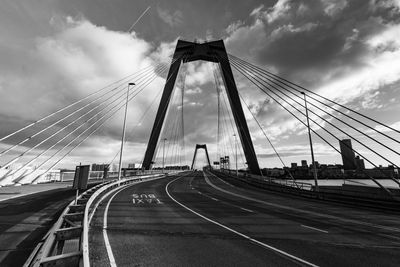 View of suspension bridge against cloudy sky