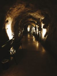 Illuminated tunnel at night