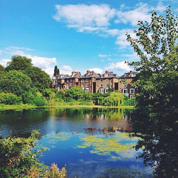 architecture, built structure, building exterior, tree, water, sky, reflection, waterfront, cloud - sky, cloud, river, day, pond, blue, outdoors, no people, lake, travel destinations, house, growth