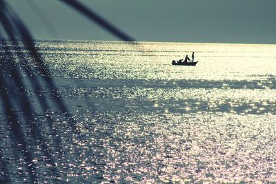 Boat in sea at sunset