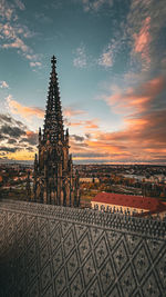 Buildings in city against sky during sunset