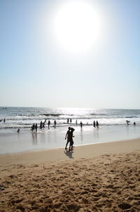 People on beach against sky