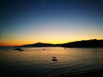 Scenic view of sea against clear sky during sunset