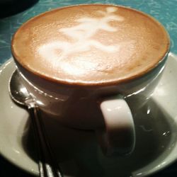 Close-up of cappuccino served on table