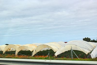 View of tent on wet shore against sky