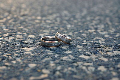 Close-up of wedding rings on metal surface
