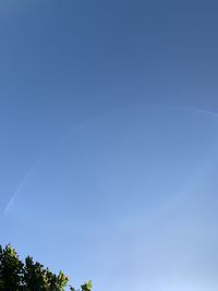 Low angle view of rainbow against clear blue sky