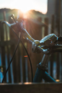 Close-up of bicycle on metal fence
