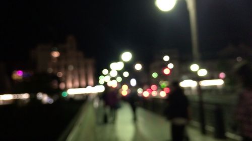 Defocused image of illuminated street lights at night