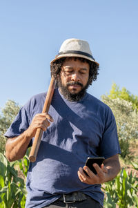 Colombian man looking at the phone person