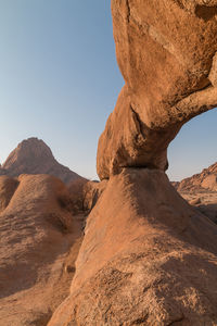 Rock formations on landscape against clear sky