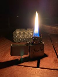 Close-up of illuminated candles on table