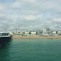 River in city against cloudy sky