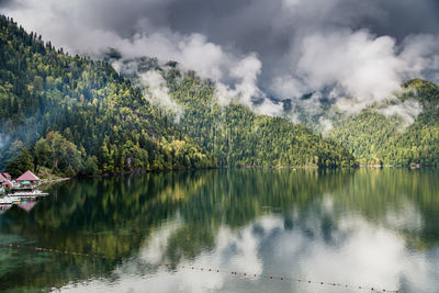 Scenic view of lake by trees against sky