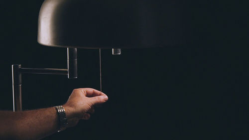 Close-up of human hand against black background