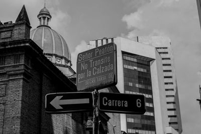 Low angle view of road sign against buildings