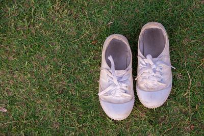 High angle view of white shoes on grass