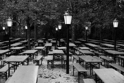 Empty chairs and tables in street during winter