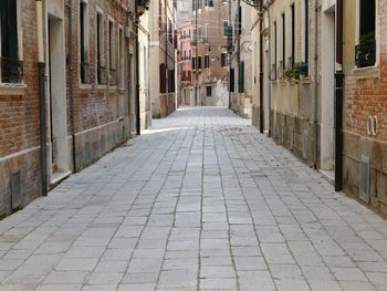 Empty alley amidst buildings in city