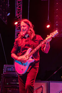 Man playing guitar at night