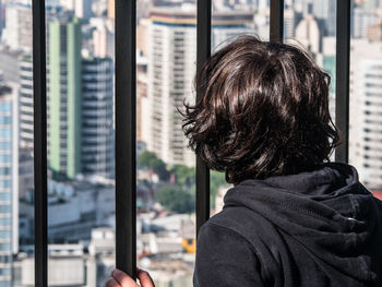 Rear view of man on glass window