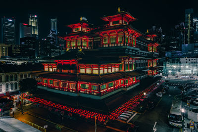 High angle view of illuminated temple against sky in city at night