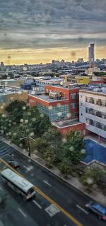 High angle view of city street and buildings against sky