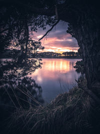 Scenic view of lake against sky at sunset